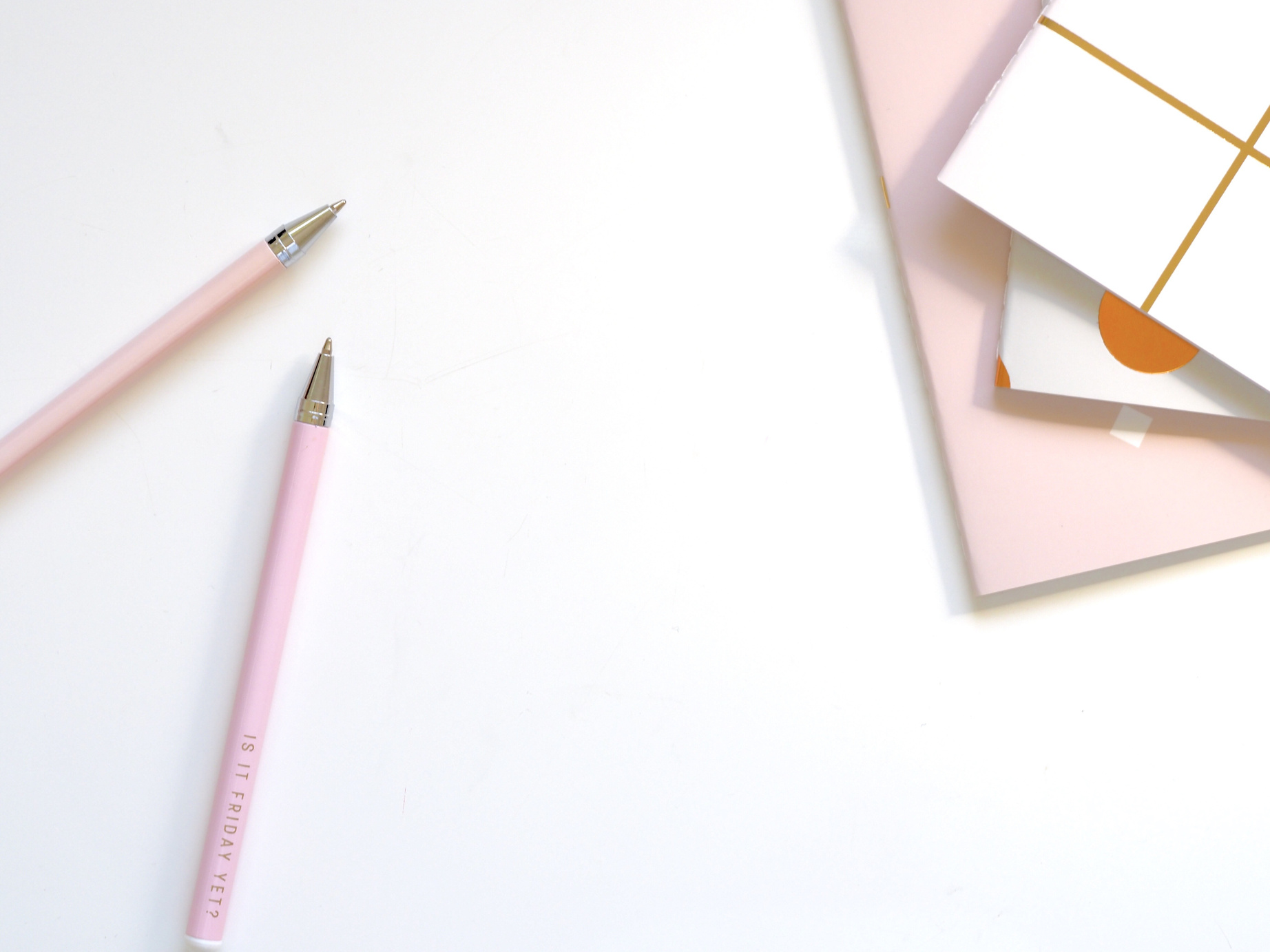 Pencils and Papers on White Desk